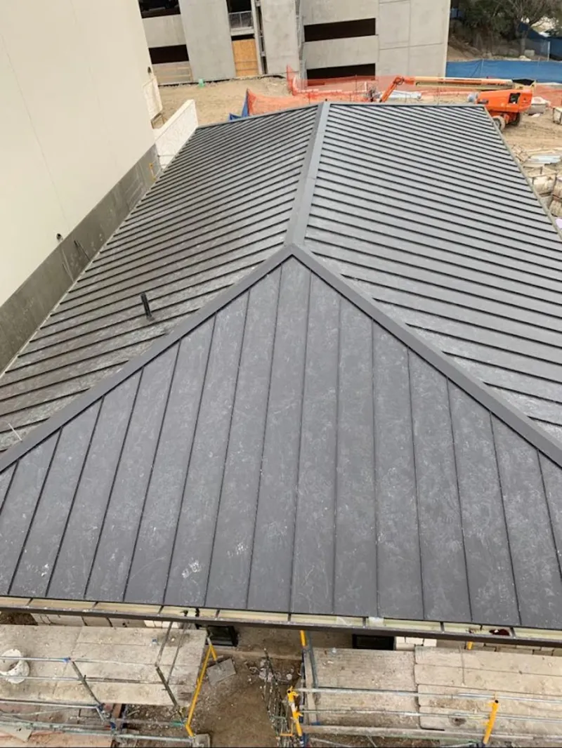 Commercial metal roof construction with crane equipment in Wimauma