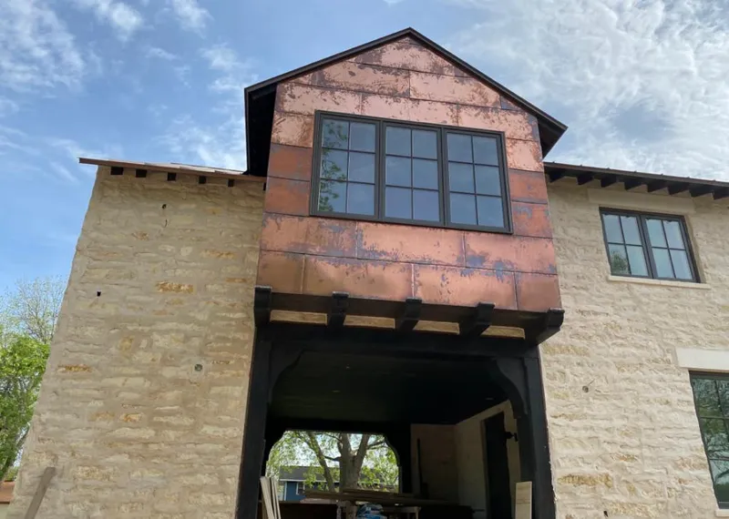 Copper metal panel facade on a stone building for Roof Repair in Wimauma